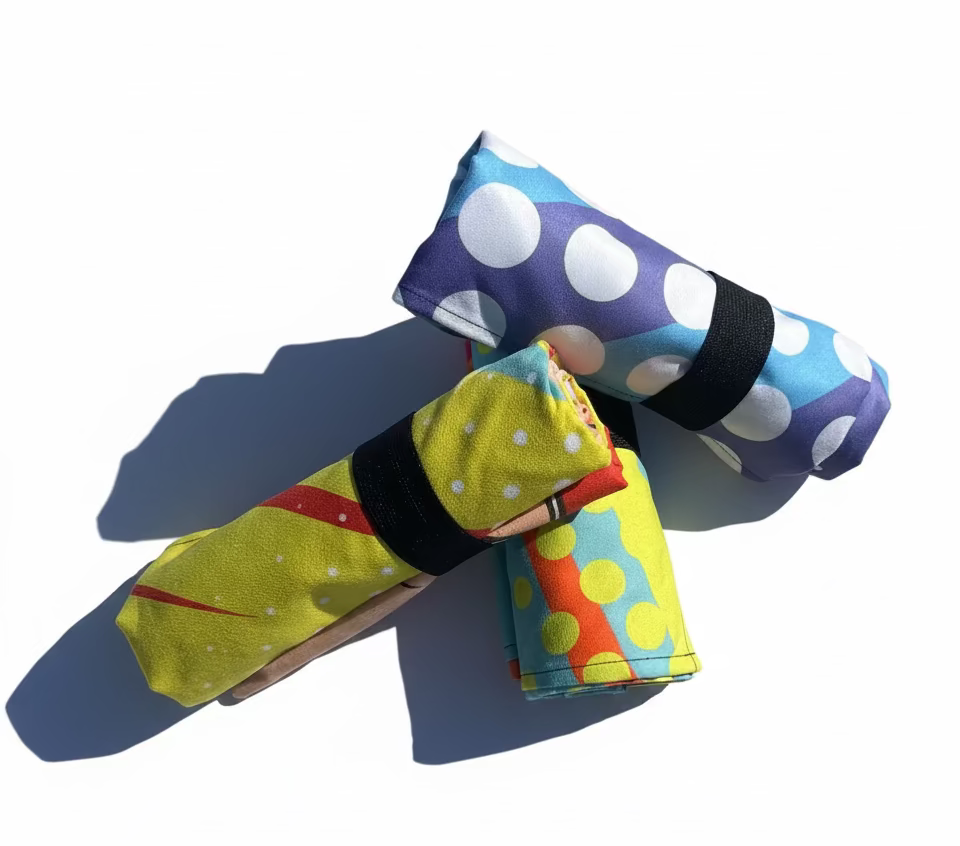 Colorful fabric rolls with polka dot patterns on a white background